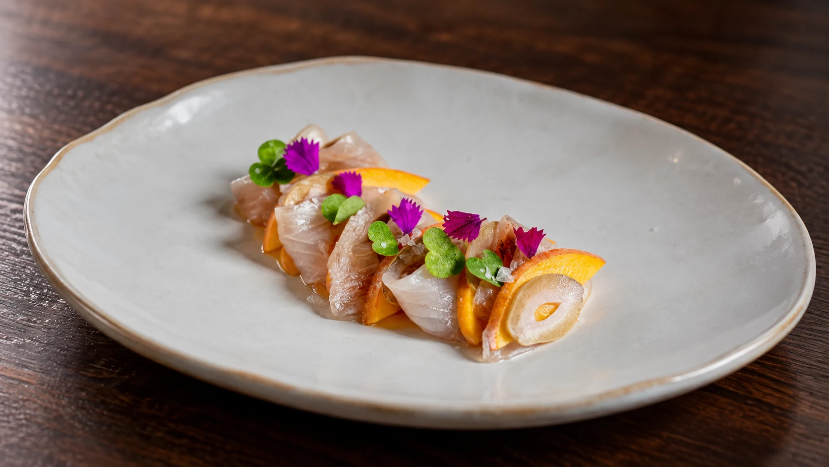 A plated starter with flowers and bright garnishes at Hestia