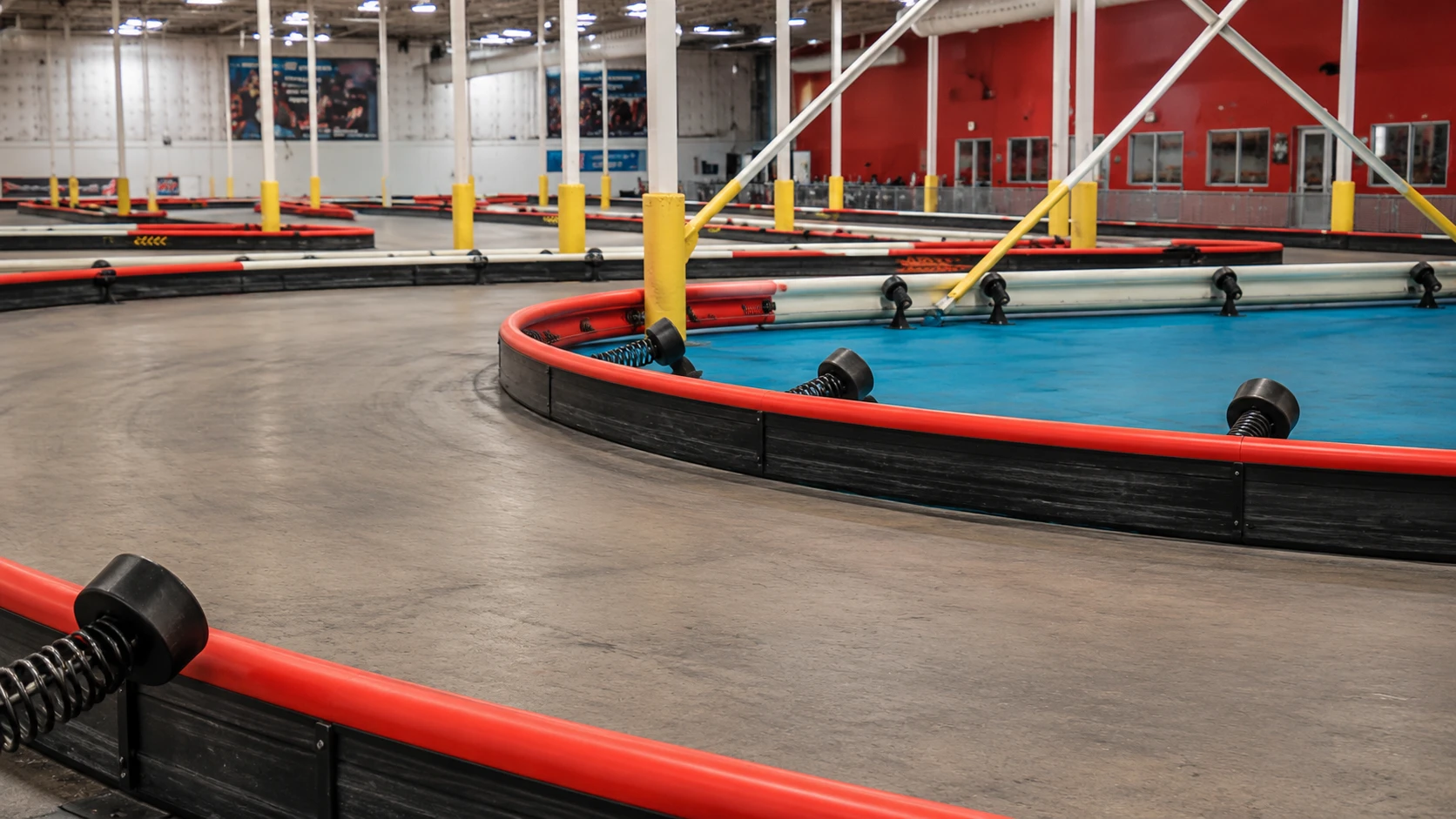 Red barriers and blue infield beside the K1 Speed Austin track