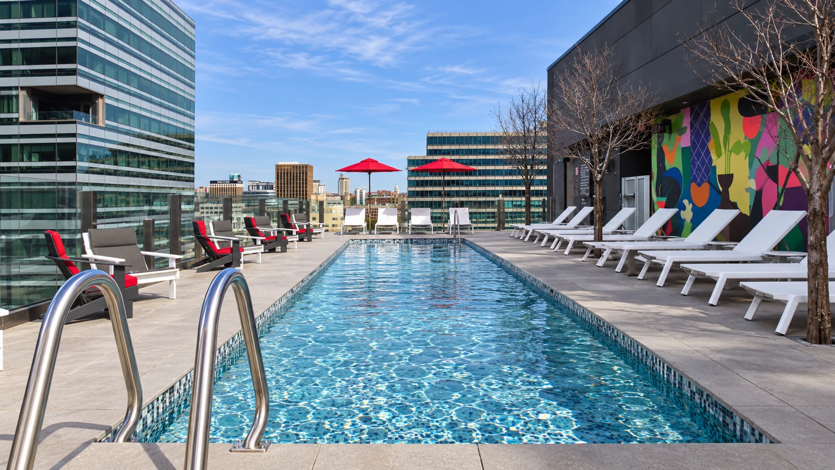 Rooftop pool, loungers and colourful mural at citizenM Austin Downtown