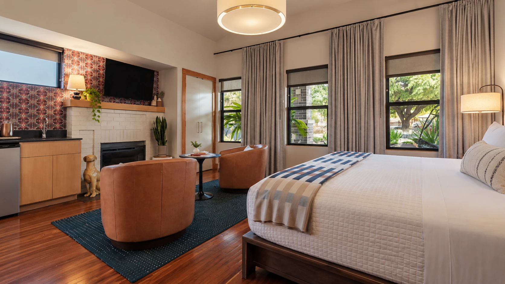 Fireplace, seating and king bed in Heywood’s King Deluxe room