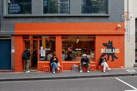 Regulars orange brick frontage and cat mural on Little La Trobe Street — AI-generated reconstruction based on reference photographs