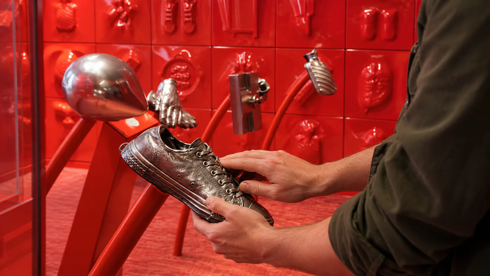 Hands creating sound effects inside ACMI’s red Foley Room