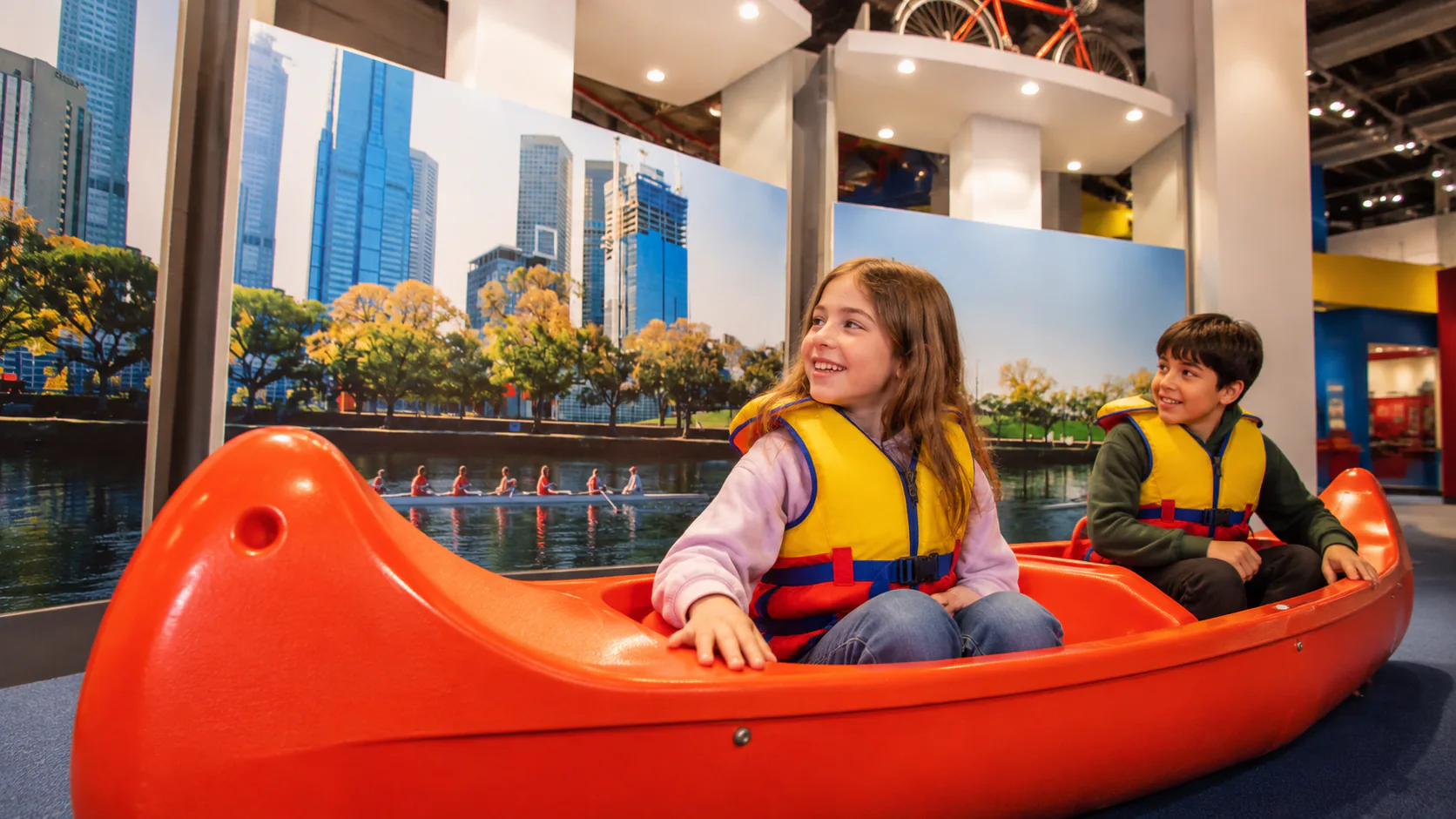 Visitors trying the orange canoe activity in Scienceworks’ Sportsworks gallery.