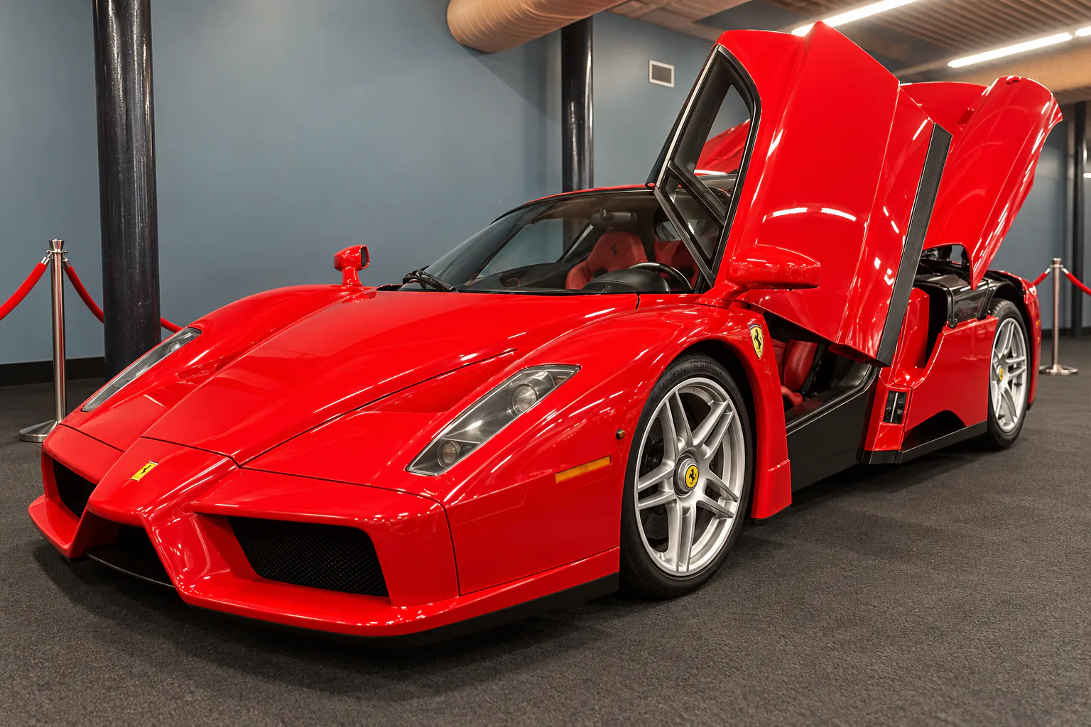 A red Ferrari Enzo with its butterfly door and engine cover raised.