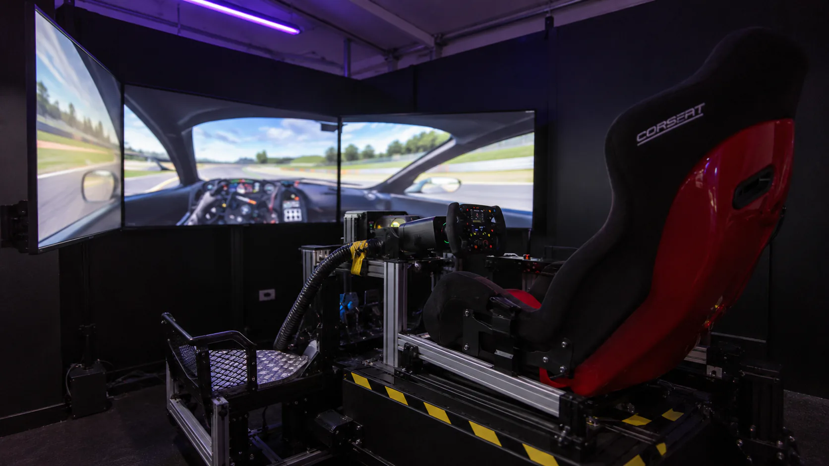 G3 Carlton’s black and red motion racing seat, aluminium frame and triple screens