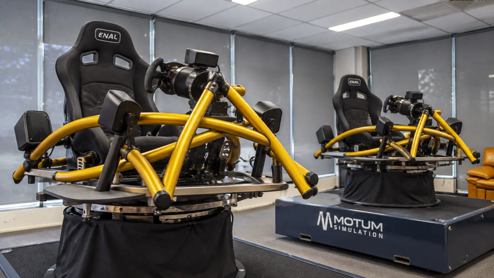 Two yellow motion racing rigs in MOTUM’s Southbank driver experience room