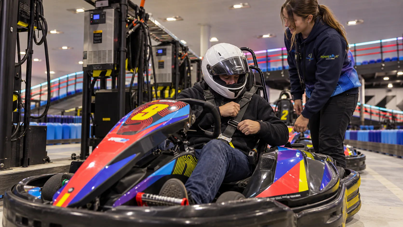 A driver preparing in an electric kart beside the Moorabbin charging lane.