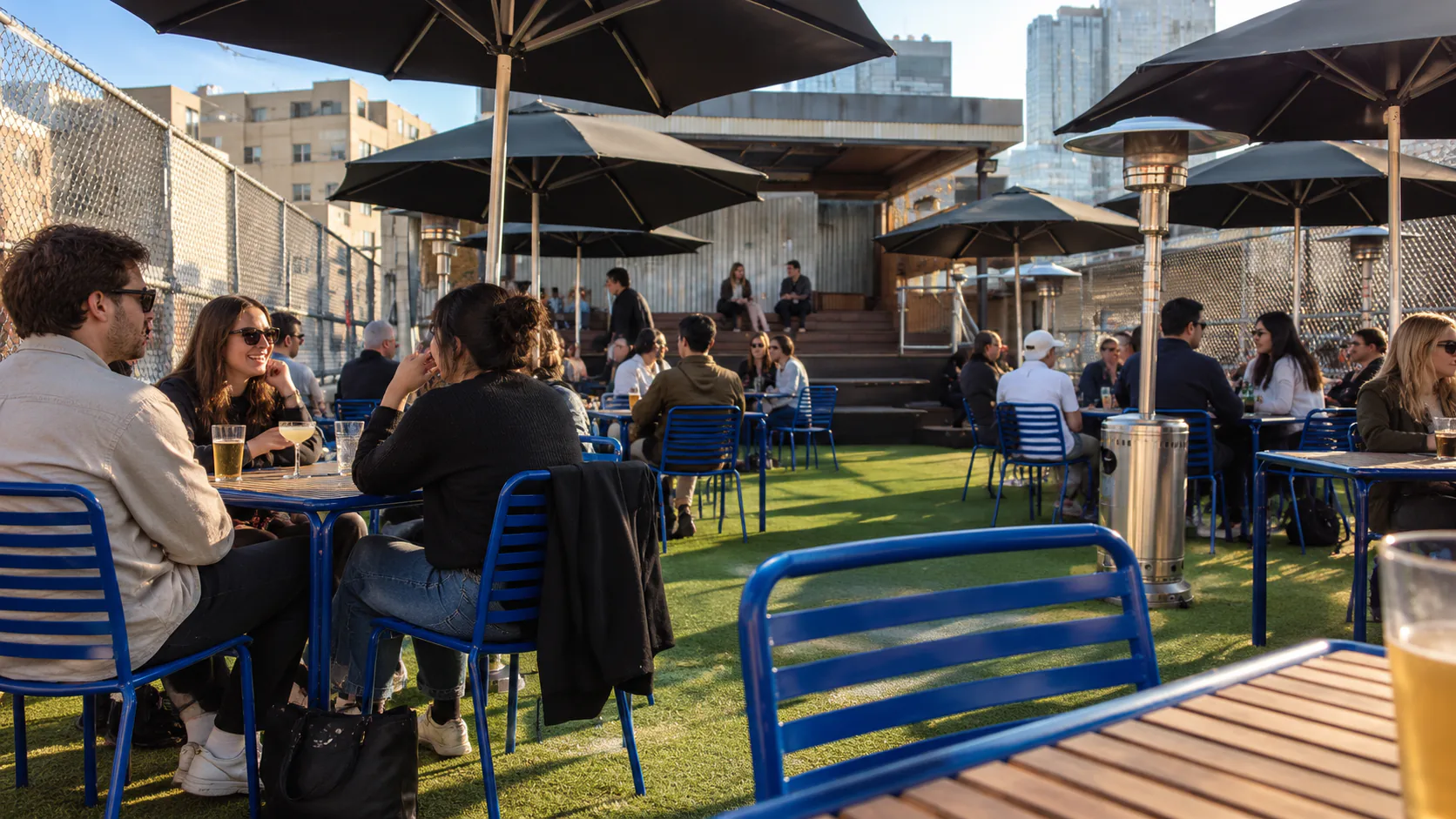 Blue chairs and black umbrellas on Rooftop Bar’s Curtin House terrace
