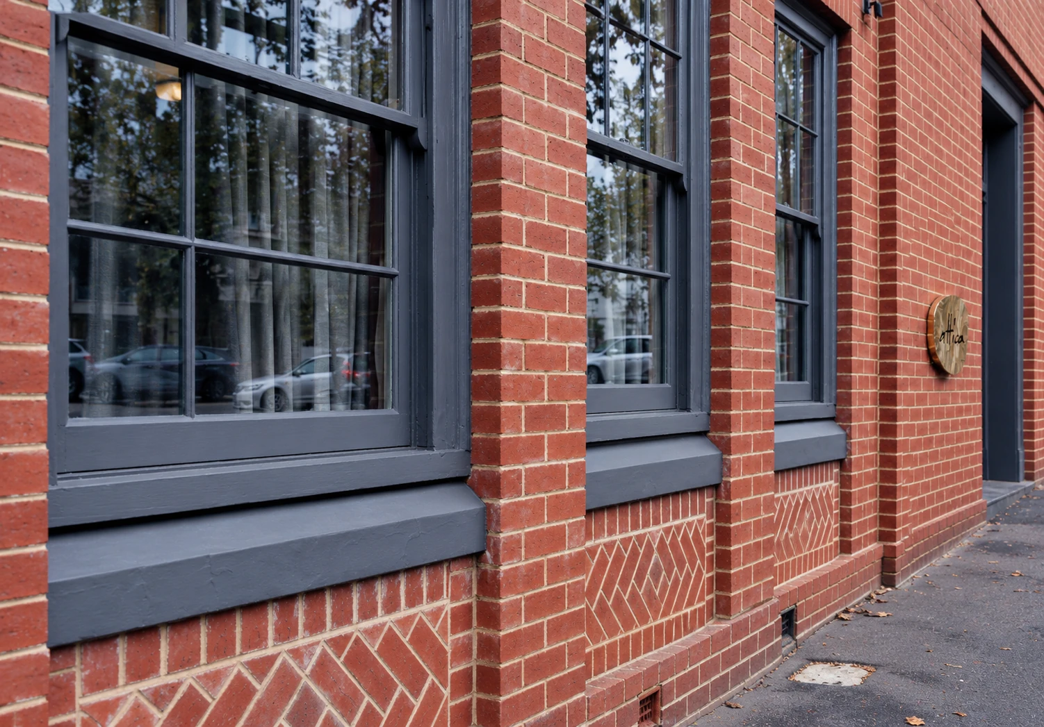 Red-brick façade and brass Attica plaque in Ripponlea