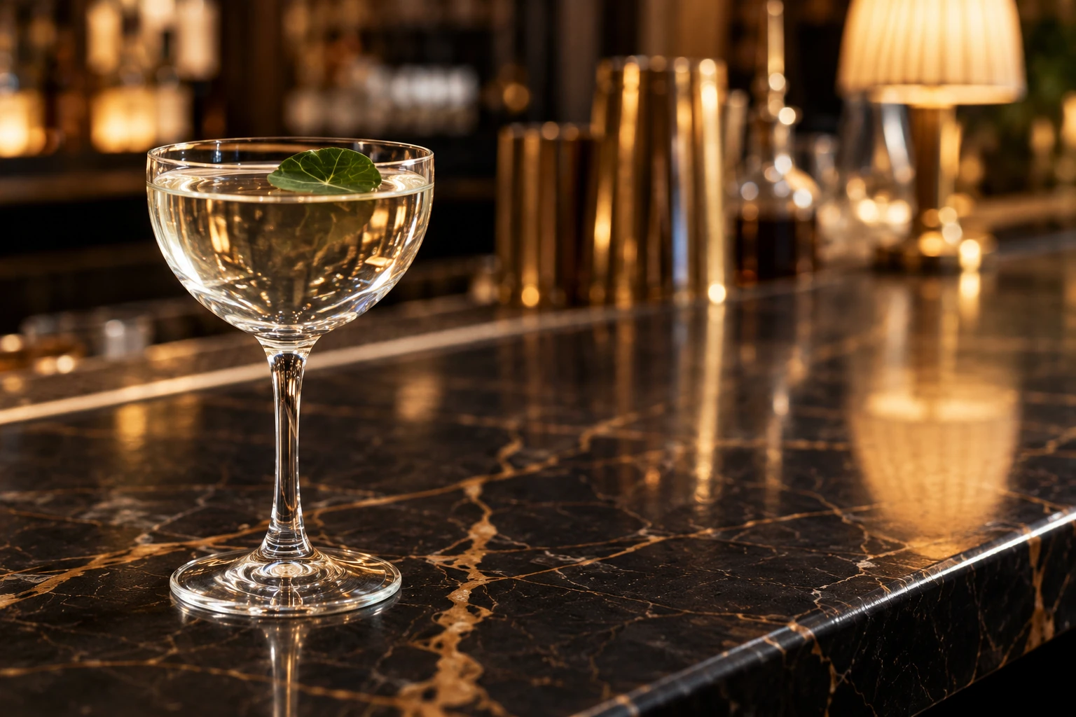 A leaf-garnished cocktail on Gimlet’s marble bar