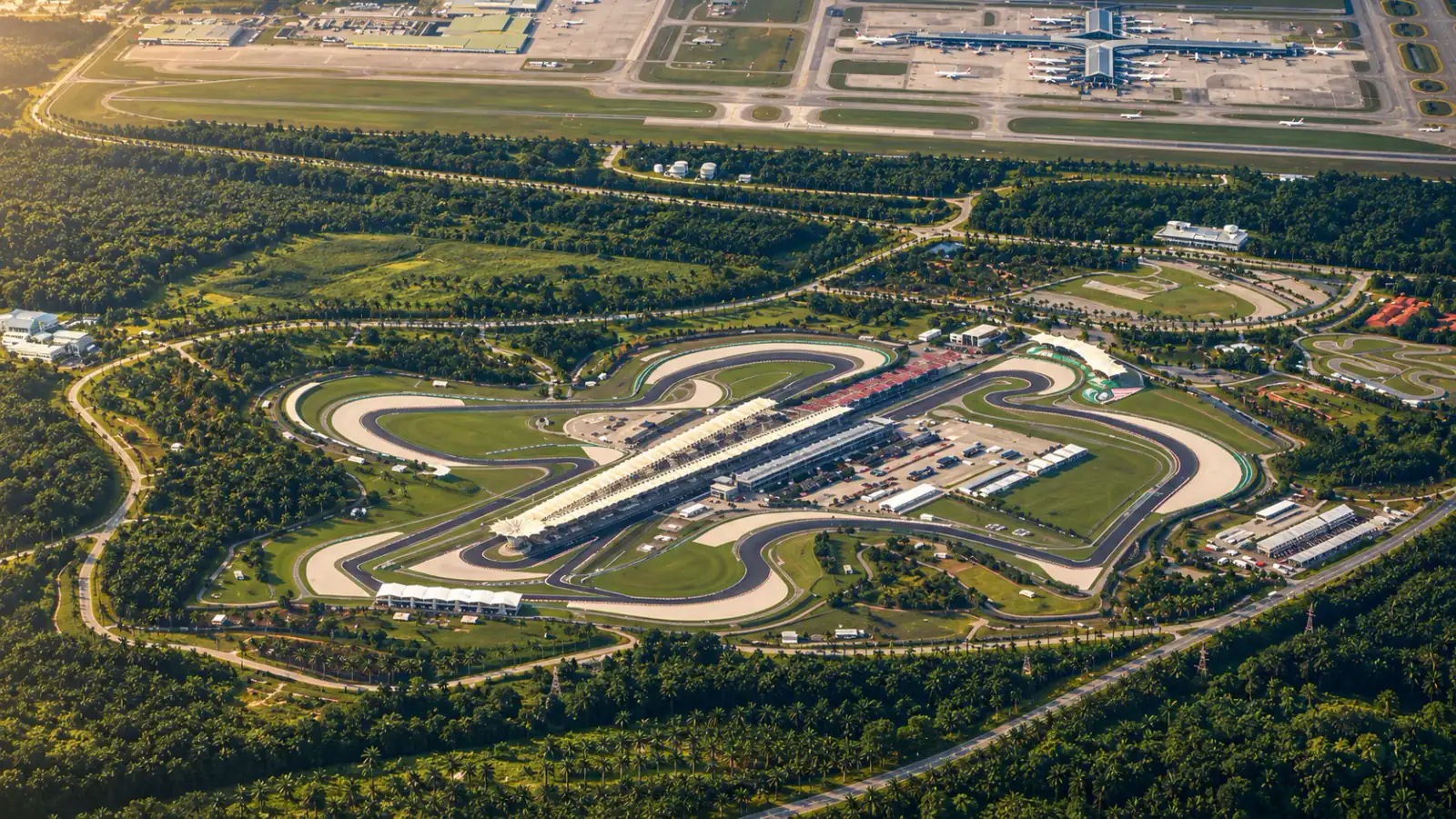 Aerial view of Sepang International Circuit in warm afternoon light.