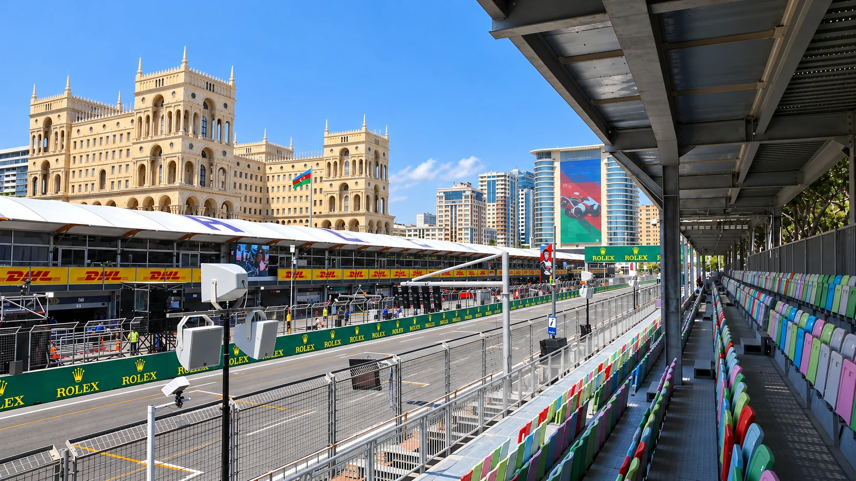 Covered multicoloured seats overlook Baku City Circuit’s pit straight, with Government House rising behind the paddock.