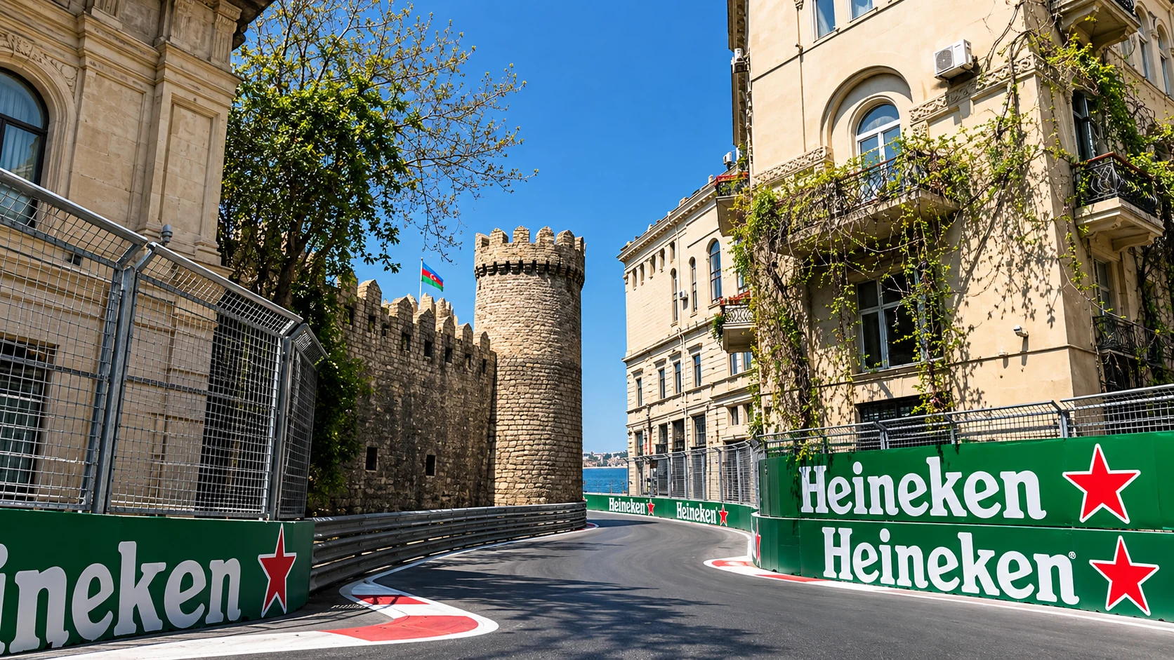 A narrow corner of Baku City Circuit runs between the Old City walls and tall stone city buildings.