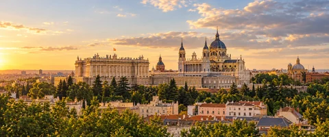 Destination artwork of Madrid: Madrid's elegant city skyline and warm pale-stone rooftops in golden late afternoon light.