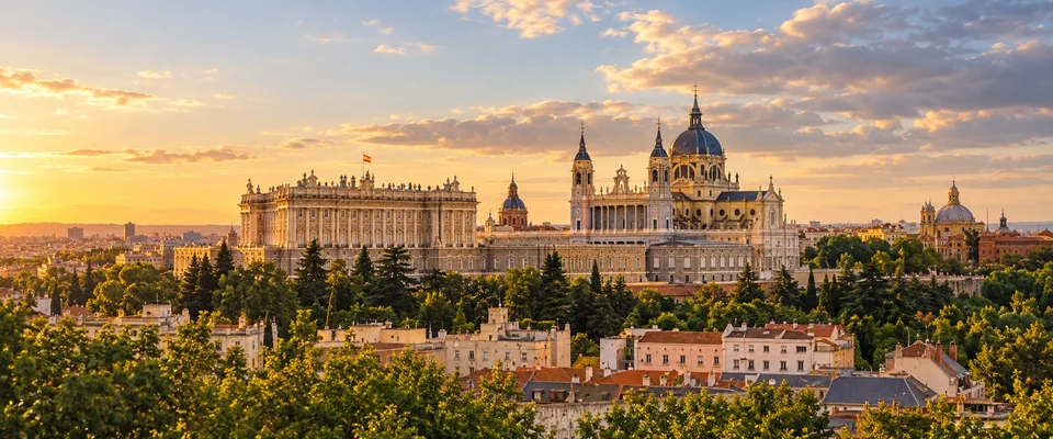 Destination artwork of Madrid: Madrid's elegant city skyline and warm pale-stone rooftops in golden late afternoon light.