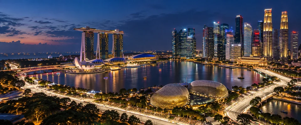 Destination artwork of Singapore: Marina Bay at night, illuminated waterfront skyline and glowing street circuit, humid blue-hour atmosphere.