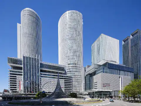 Editorial illustration of the station complex: JR Gate Tower Hotel is in the rectangular tower, not Marriott’s cylindrical towers.