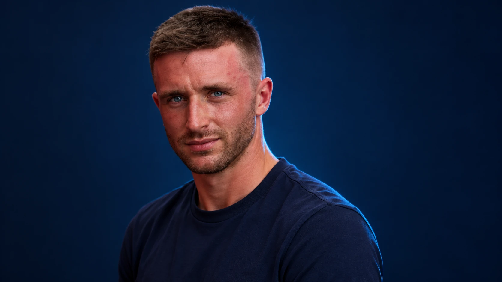 Joel Eriksson in a navy shirt against a dark background.