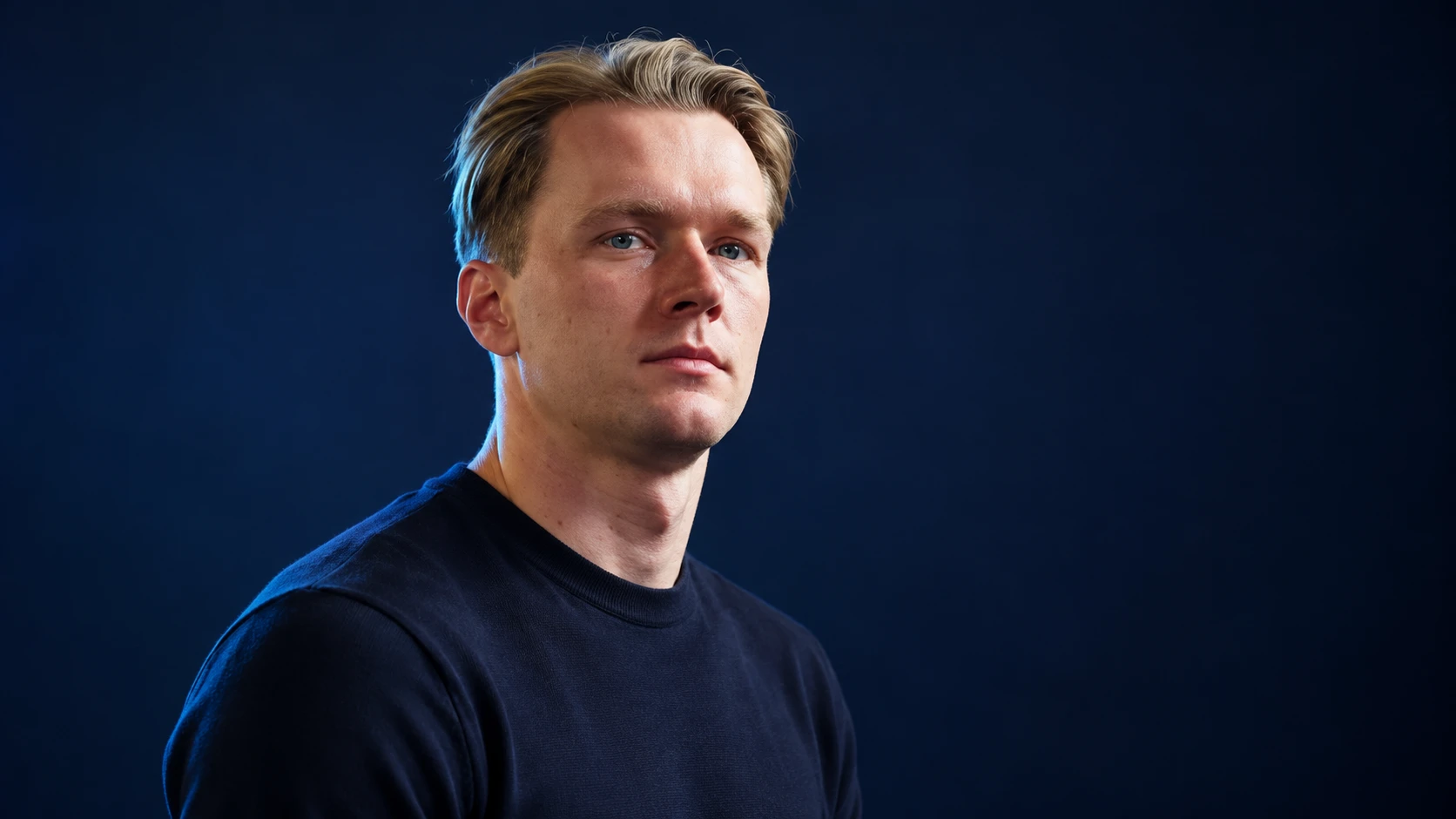 Maximilian Günther in a navy shirt against a dark background.