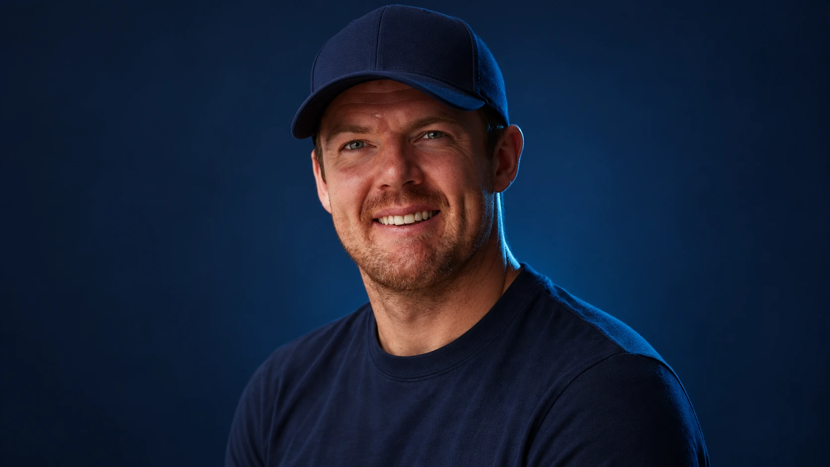Nick Cassidy in a navy shirt against a dark background.