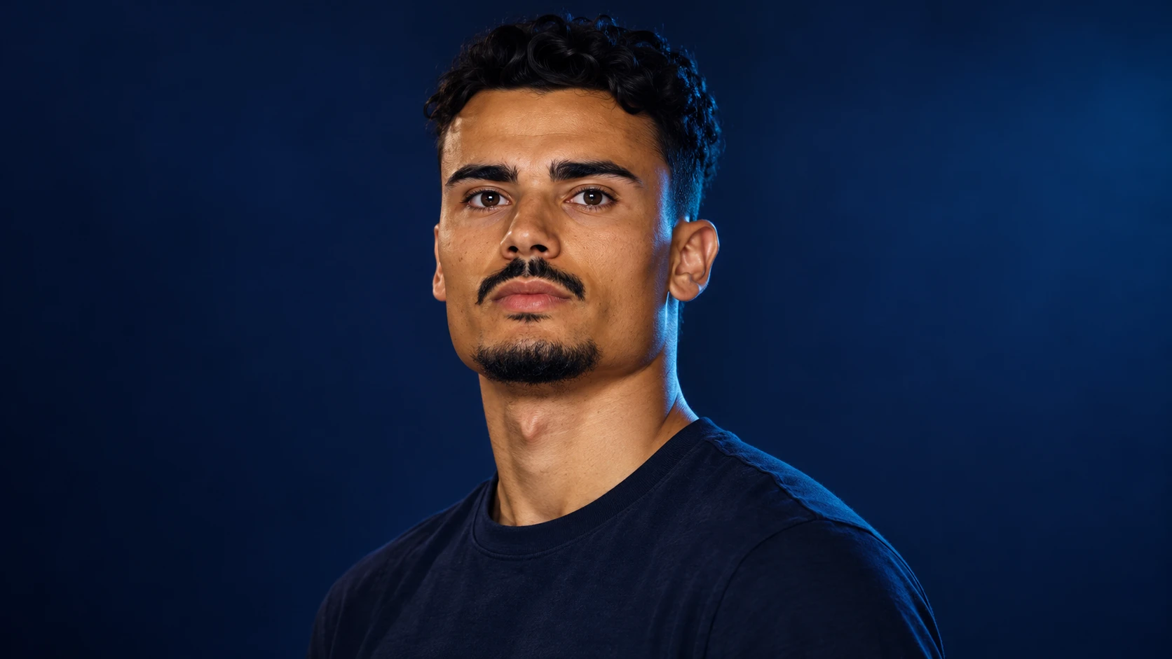 Pascal Wehrlein in a navy shirt against a dark background.