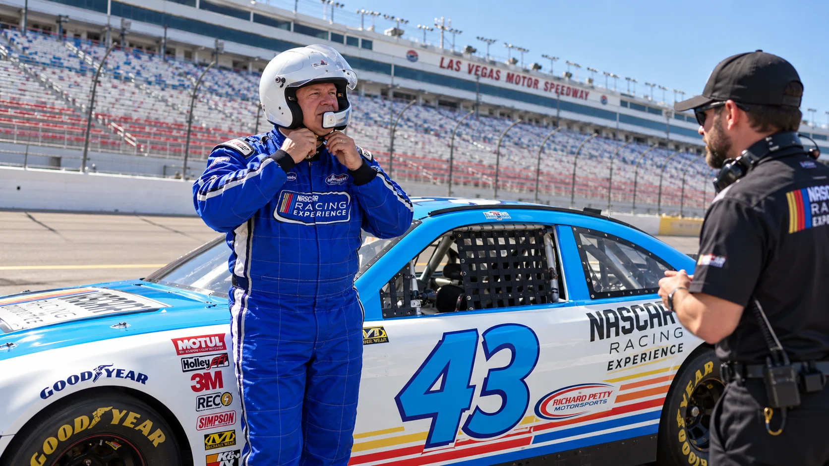 A guest preparing beside a NASCAR experience car