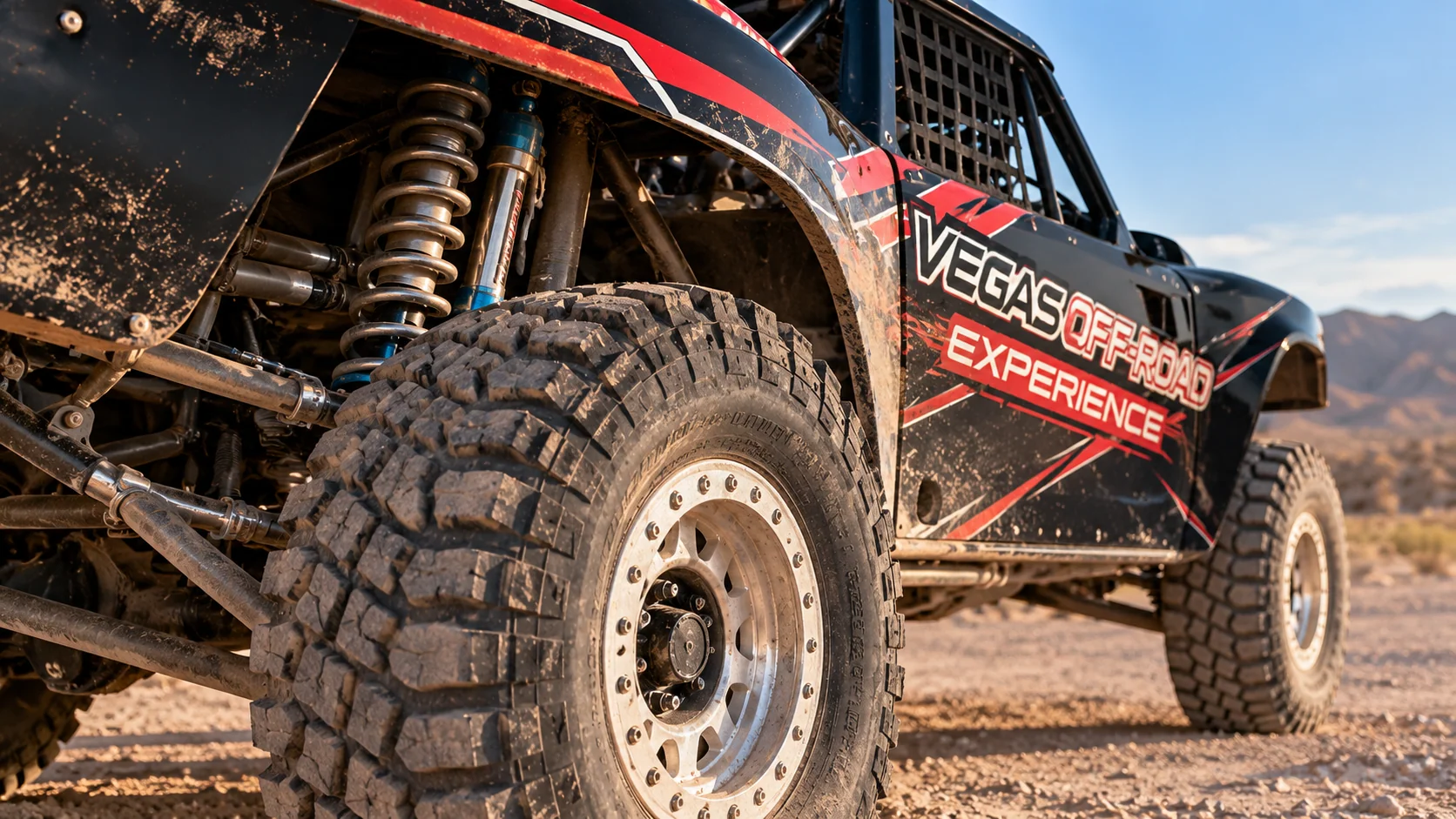 A Baja race truck’s off-road tyre, suspension, mesh window and black-and-red bodywork