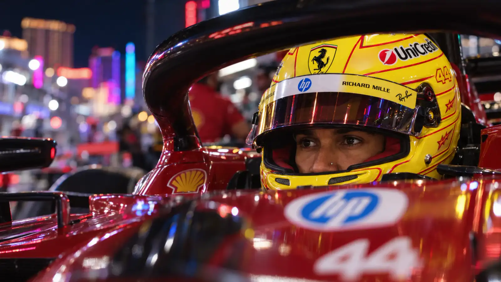 Lewis Hamilton in his racing helmet under Las Vegas night lights.