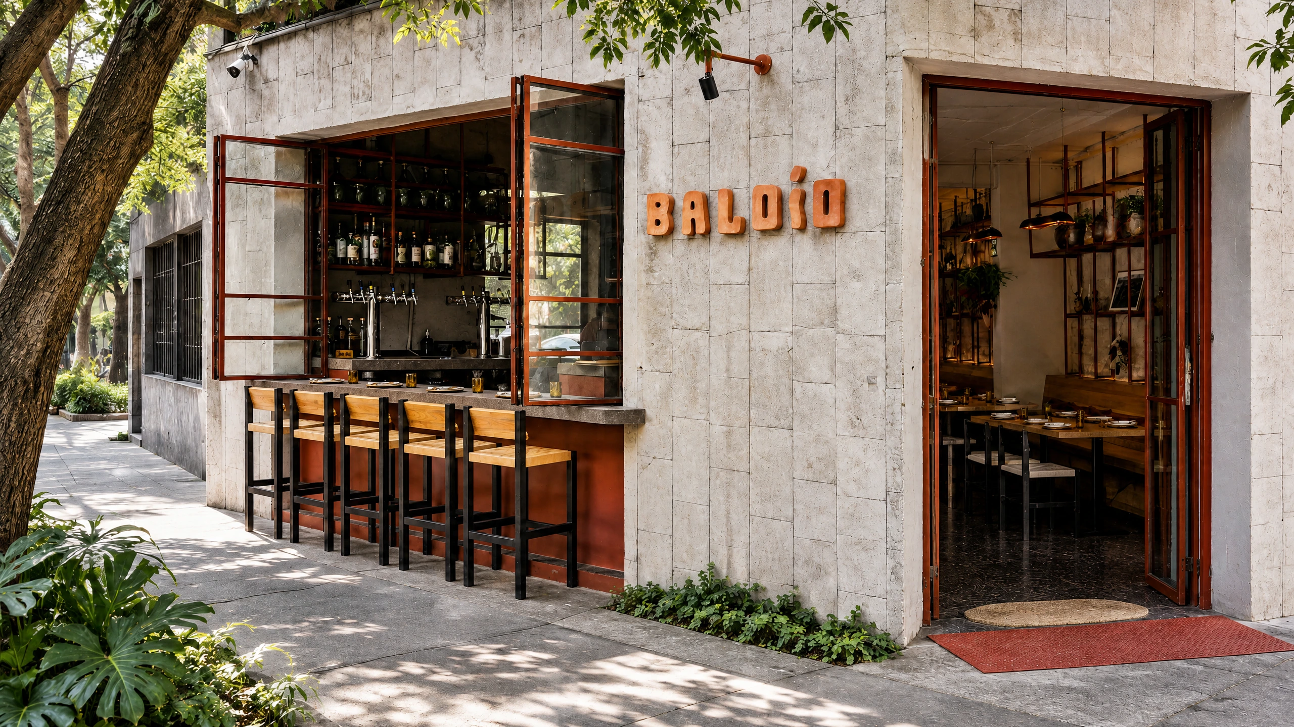 Baldío’s pale stone corner façade, open bar window and entrance in Condesa