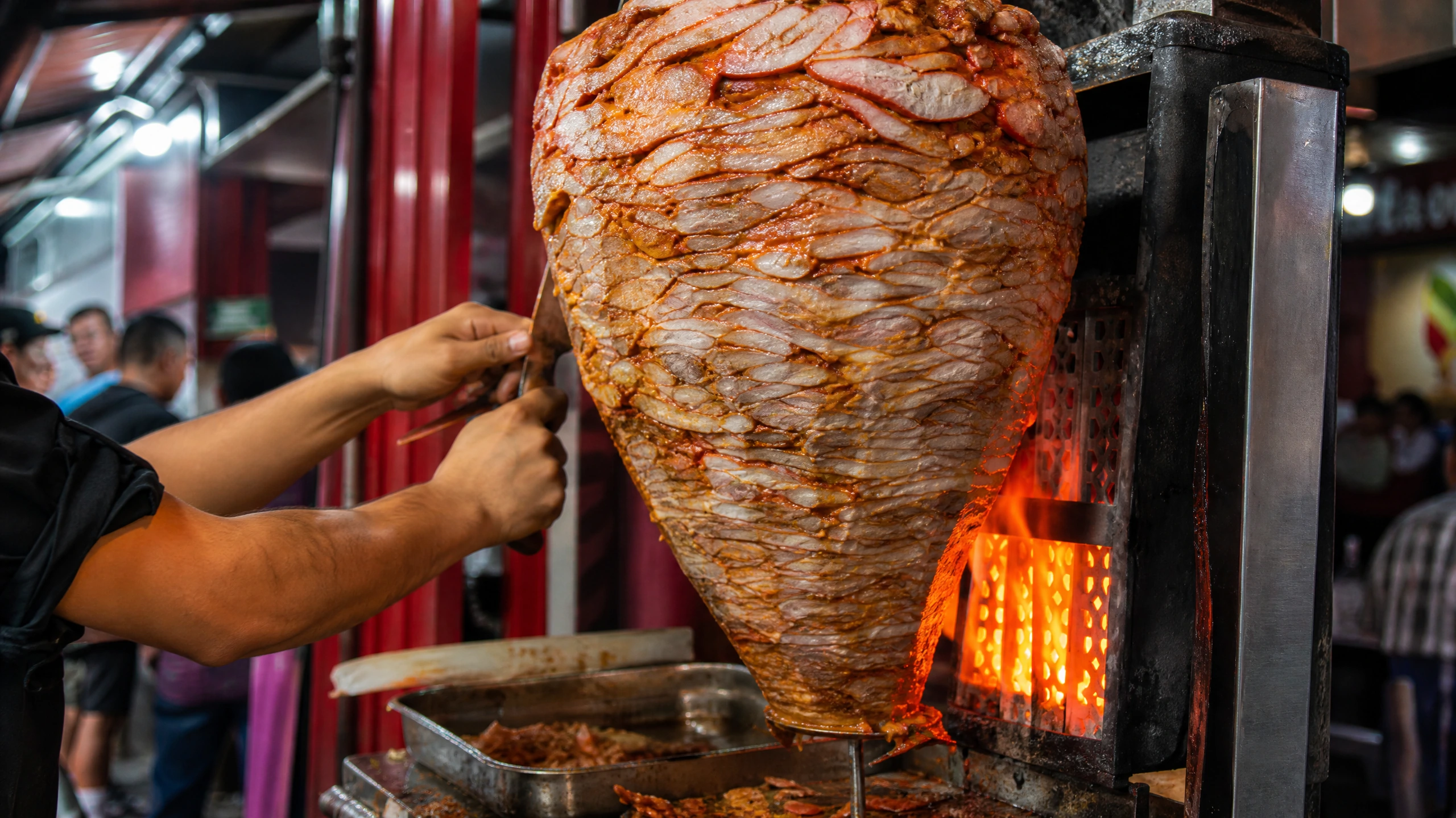 The al pastor trompo and roasting flame at El Vilsito after dark