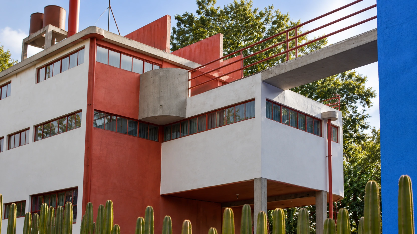 The raised bridge and red-and-white studio architecture