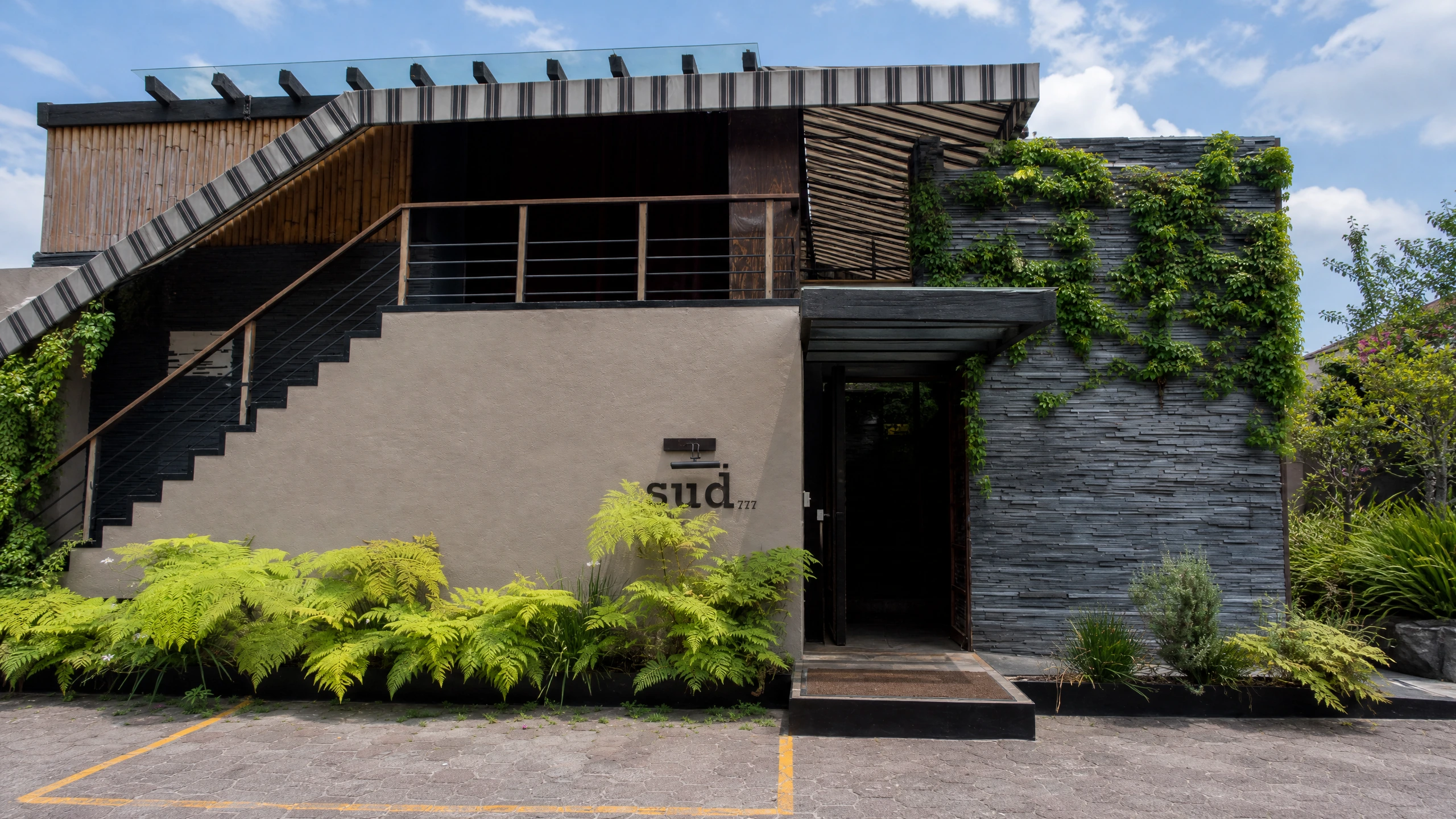 Sud 777’s planted entrance and exterior stair in Pedregal