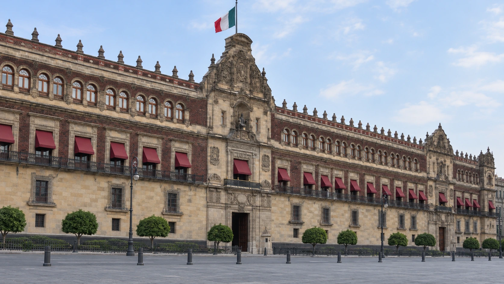 Carved stonework and red awnings along the Zócalo’s civic frontage