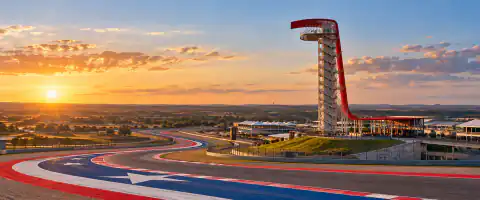 Destination artwork of Austin: Circuit of the Americas in Texas, distinctive red observation tower, sweeping track, red white and blue runoff and open rolling Texas landscape.