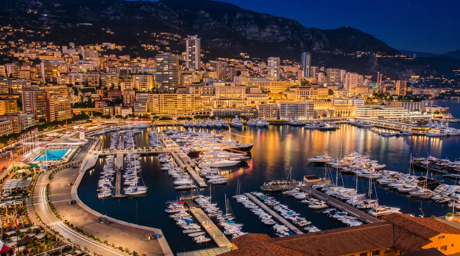 Monaco harbour packed with superyachts and F1 cars speeding through the Swimming Pool chicane
