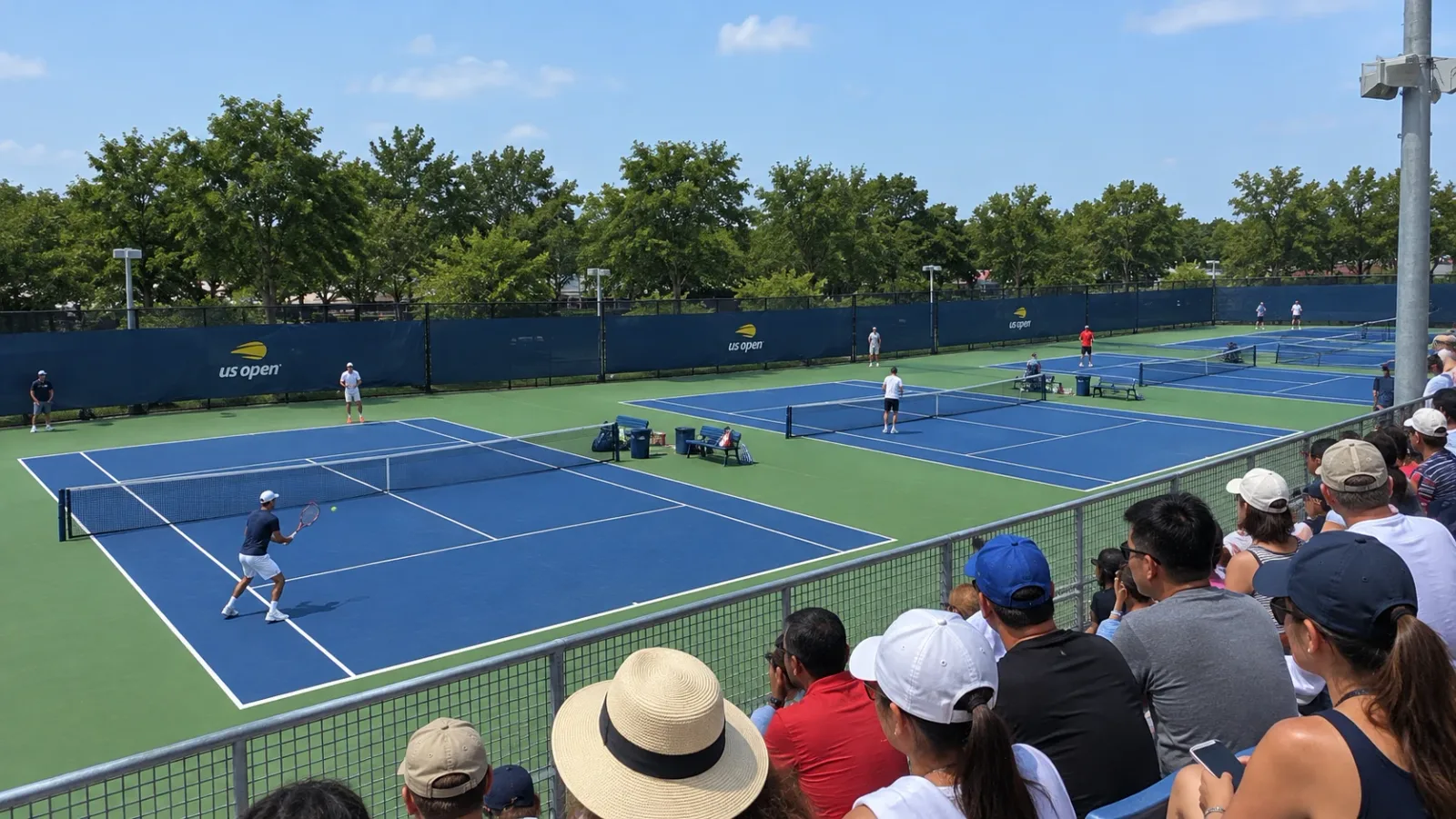 Blue practice courts beside the US Open spectator viewing terrace.