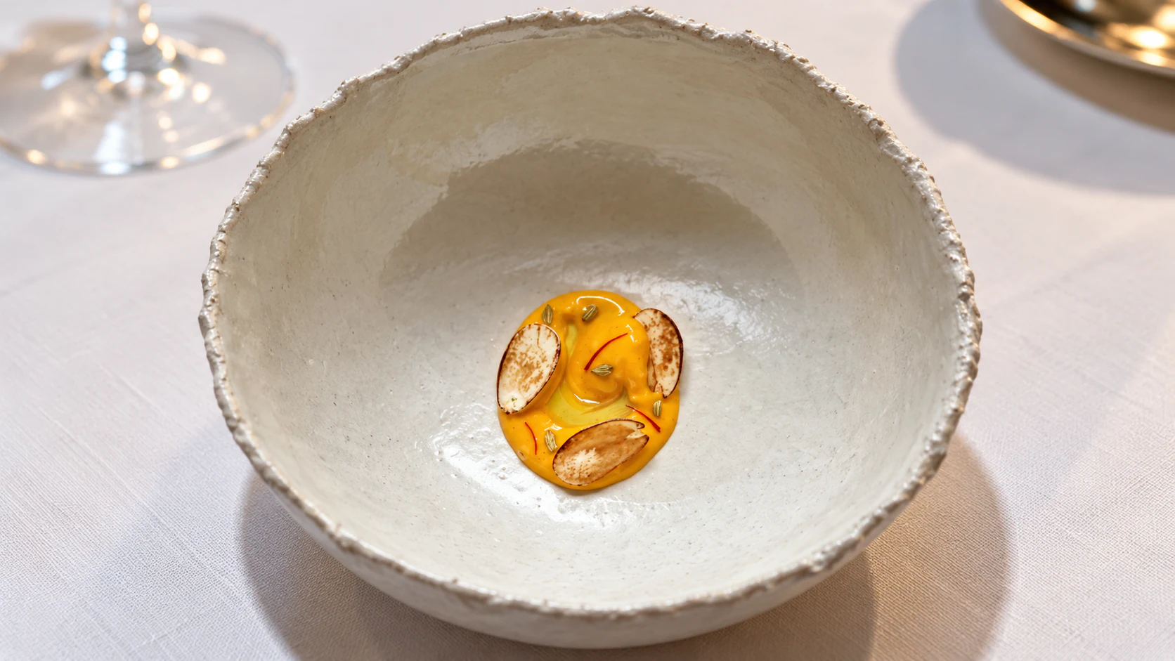 Golden course with almond garnish
