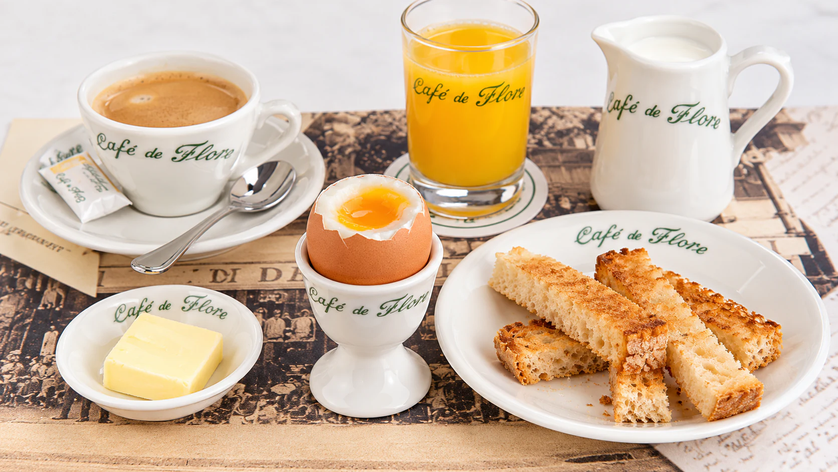 Soft-boiled egg in an egg cup, with bread soldiers and butter, at Café de Flore.