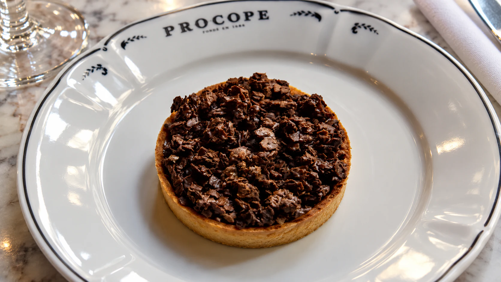 Chocolate and coffee tart by Christelle Brua, finished with a dark chocolate crumb topping.