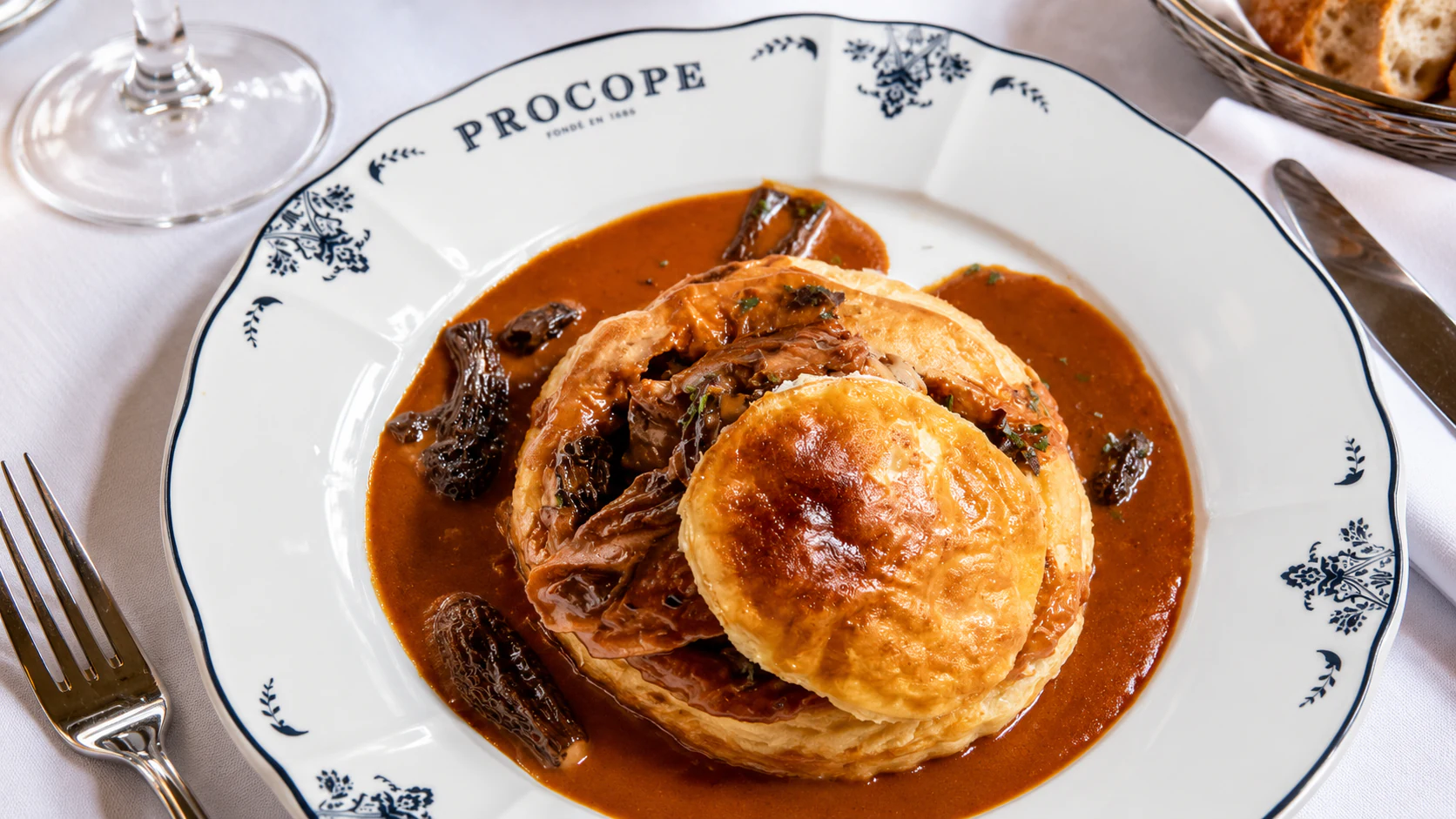 Vol-au-vent aux morilles: a round puff-pastry case with morel mushrooms and sauce.