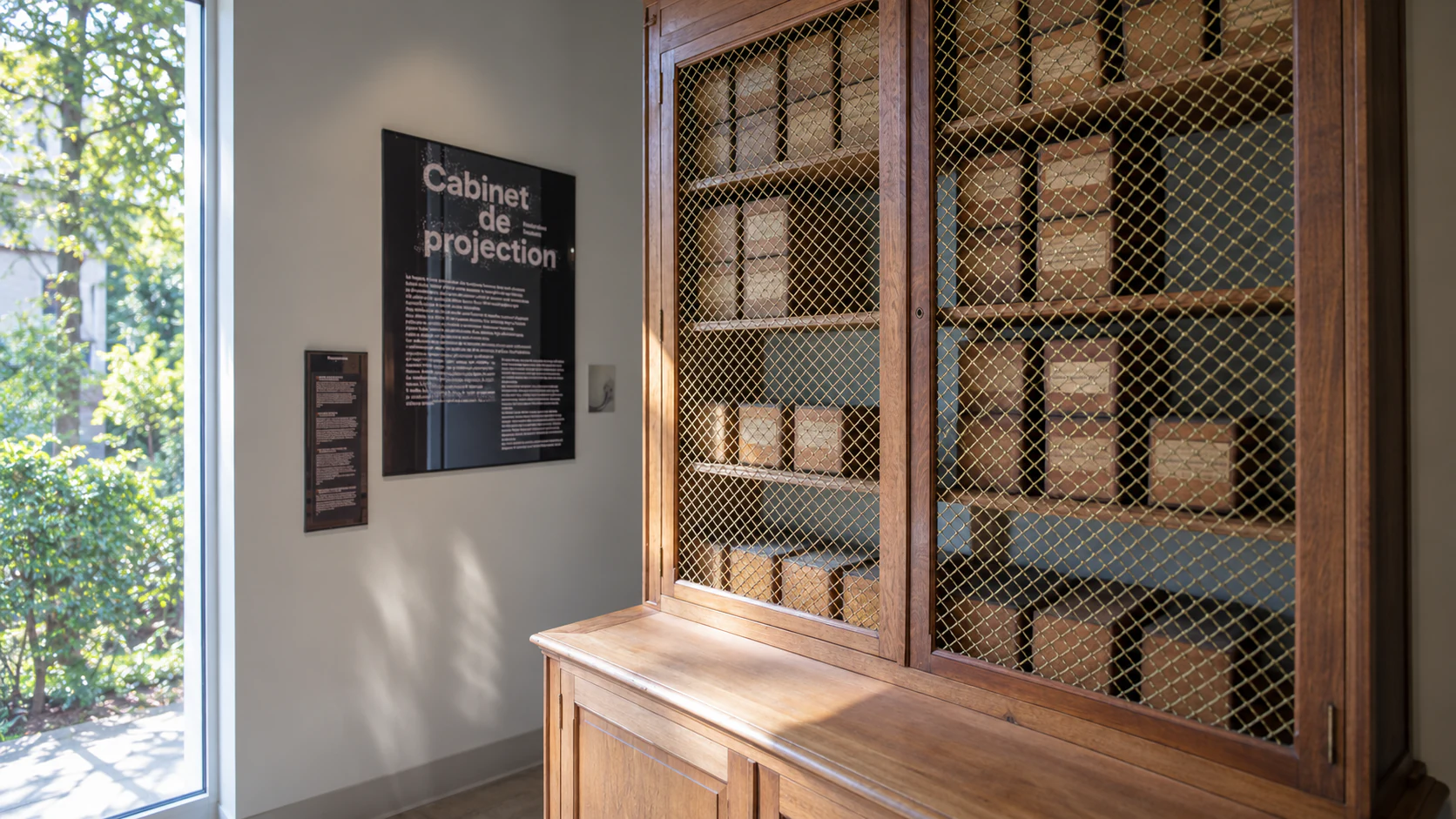 The Salle des Plaques, with historic glass-plate storage behind a protective grille.
