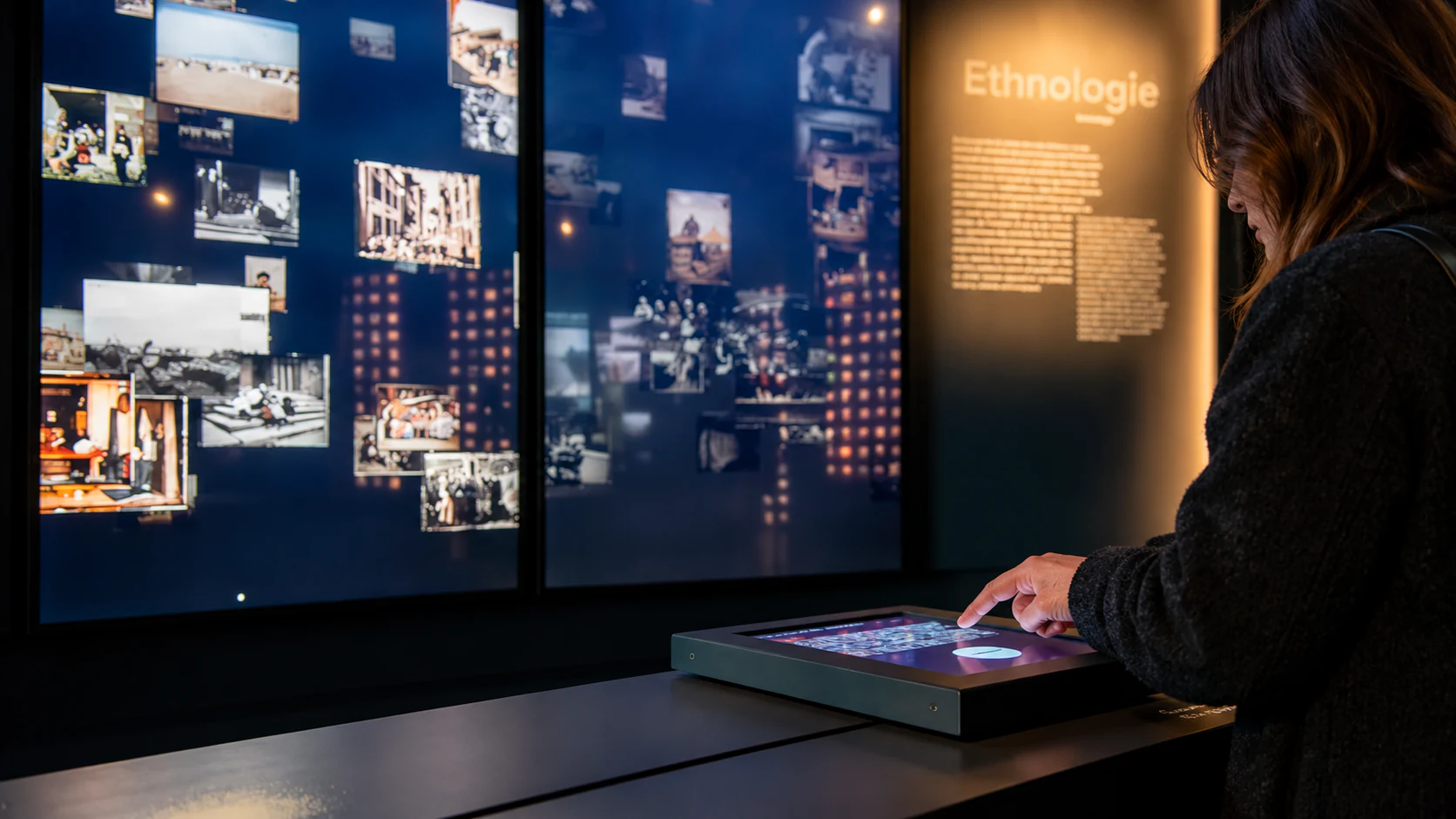 An interactive table and the ethnology image display in the Archives of the Planet exhibition.