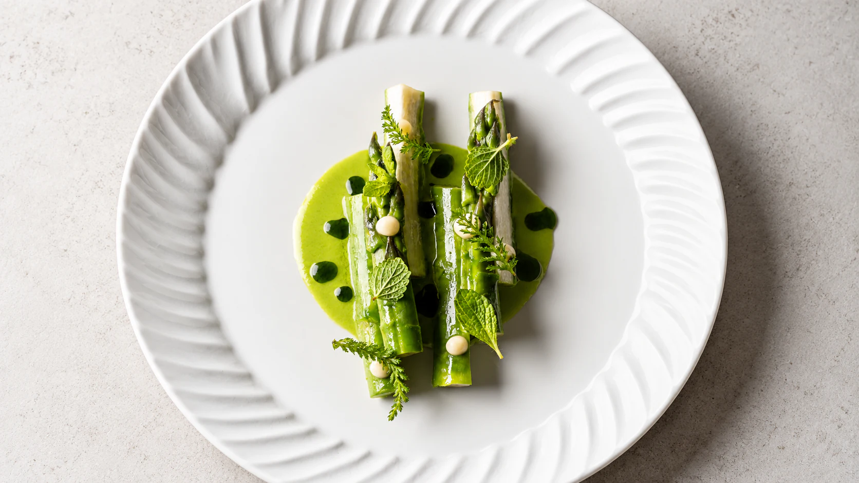 Green and white asparagus with bright herb sauce at David Toutain