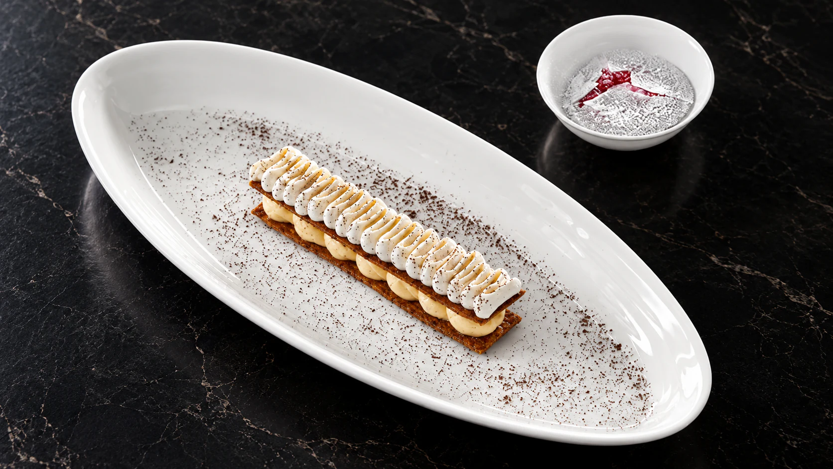 Layered pastry and piped cream on an oval platter at Le Jules Verne