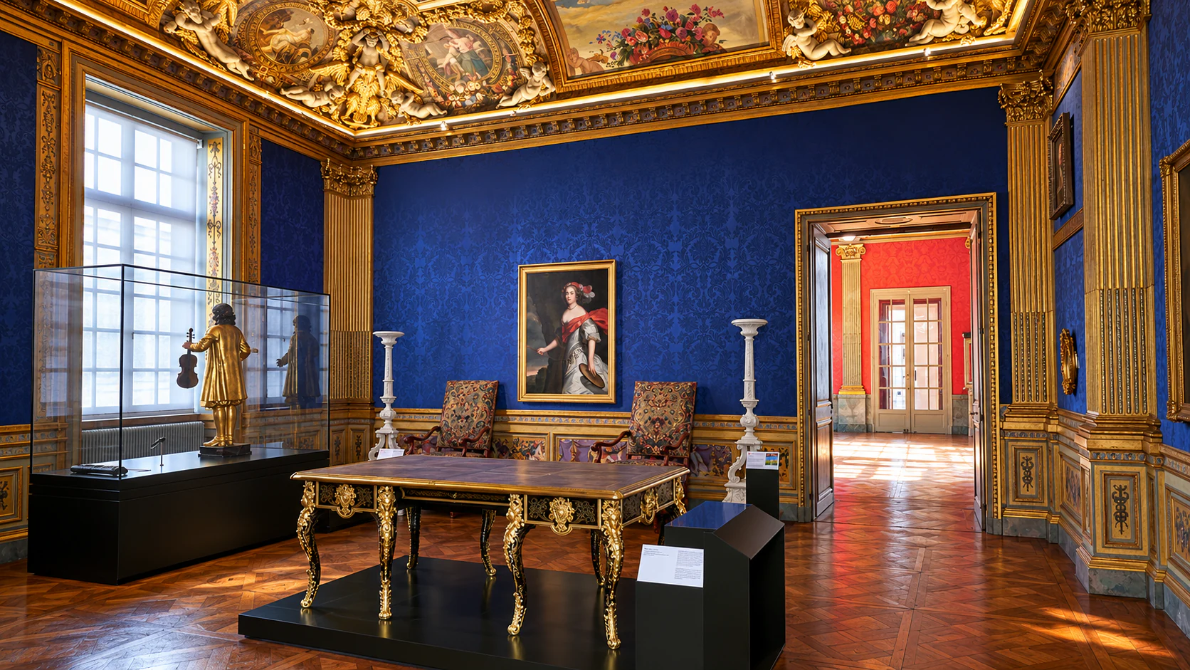 Blue walls and gilded ceiling in Musée Carnavalet’s La Rivière salon