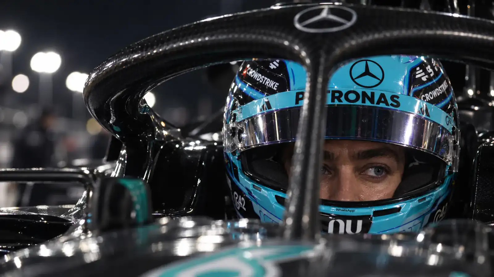George Russell’s focused eyes beneath his blue helmet and carbon-fibre halo.