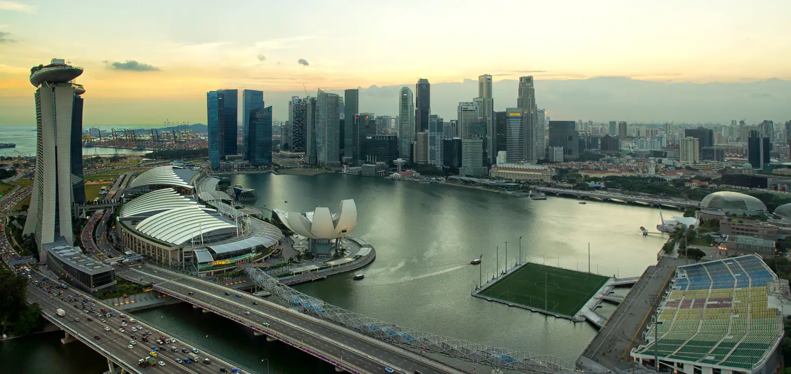Singapore Flyer and Marina Bay skyline illuminated at dusk during F1 weekend
